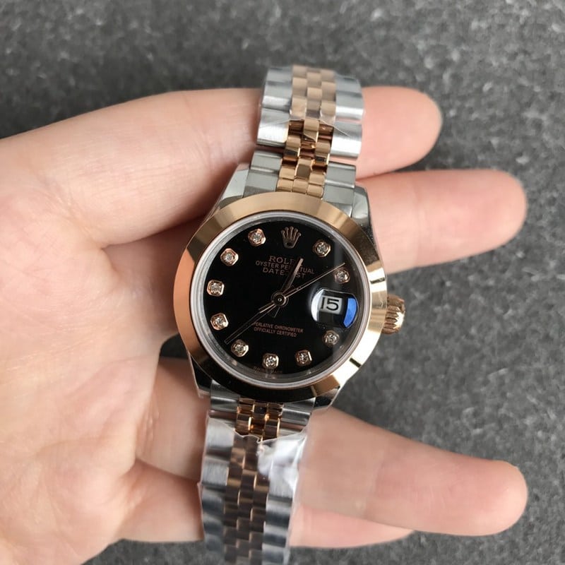 Rolex Datejust 28mm mechanical watch, fluted bezel, rose gold, black dial, diamond hour markers, front view