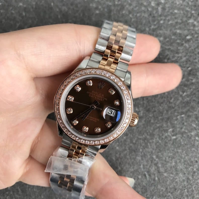 Refined Rolex Datejust women's watch, 28mm, mechanical bezel with diamonds, rose gold, coffee-colored dial, diamond hour markers, front view.