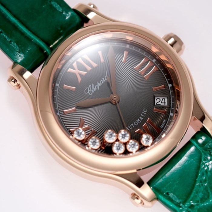 Top Chopard women's watch, black dial, green strap, HAPPY DIAMONDS series, mechanical leather strap, front view.