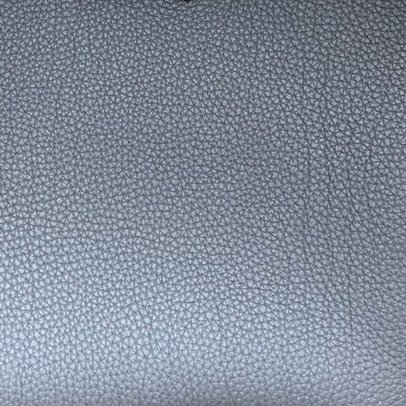 The smaller grained, veined texture of Togo leather.