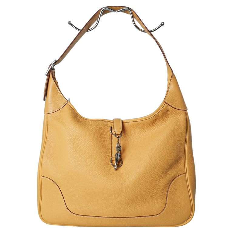 Gold grain leather "Trim II " bag with silver hardware Hermès