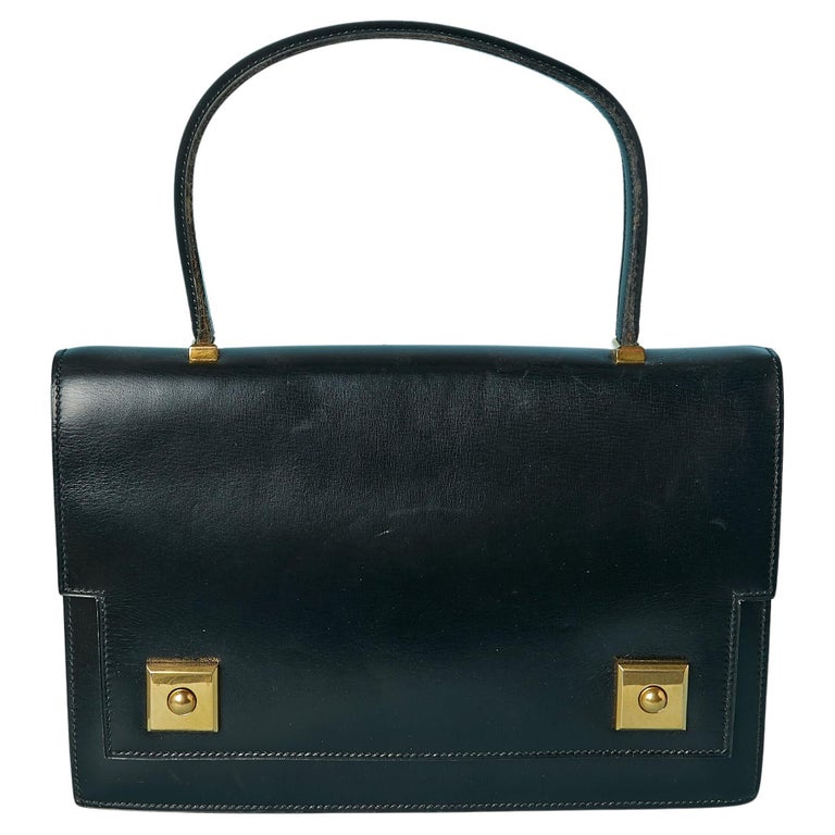 Iconic "Piano" top handle bag  in black leather Hermès